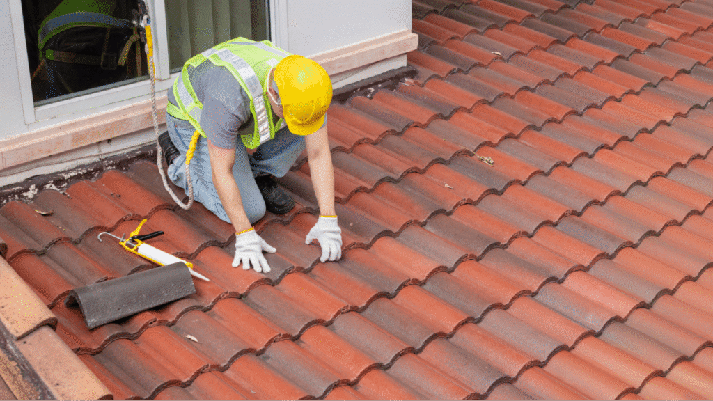 professional roofing crew installing new wood decking and underlayment on a residential house during a full roof replacement.